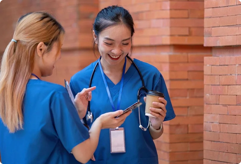 happy female nurses outside the hospital