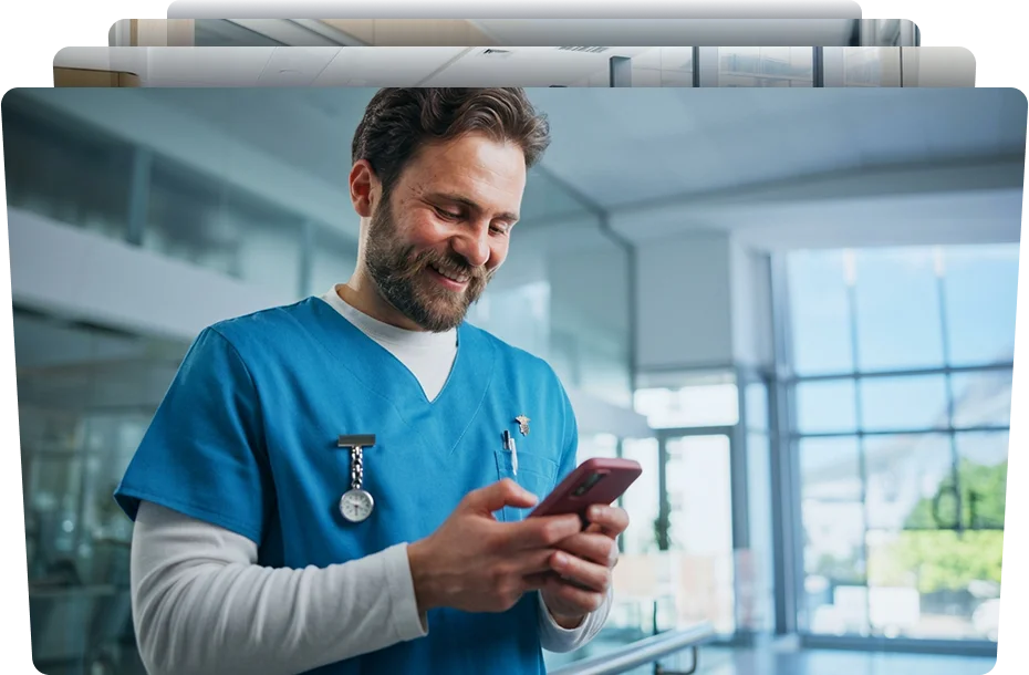happy male nurse holding his smartphone in the clinic