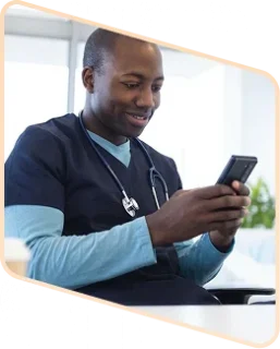 happy male nurse reading his smart phone